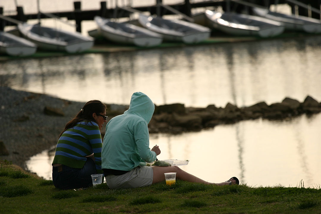 SMCM students eating on the riverfront by the boat dock