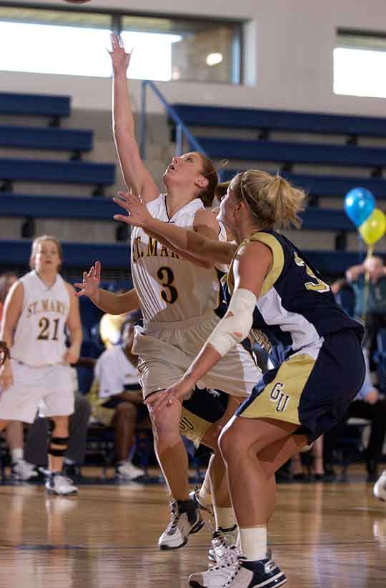 SMCM Women's Basketball players on the court.