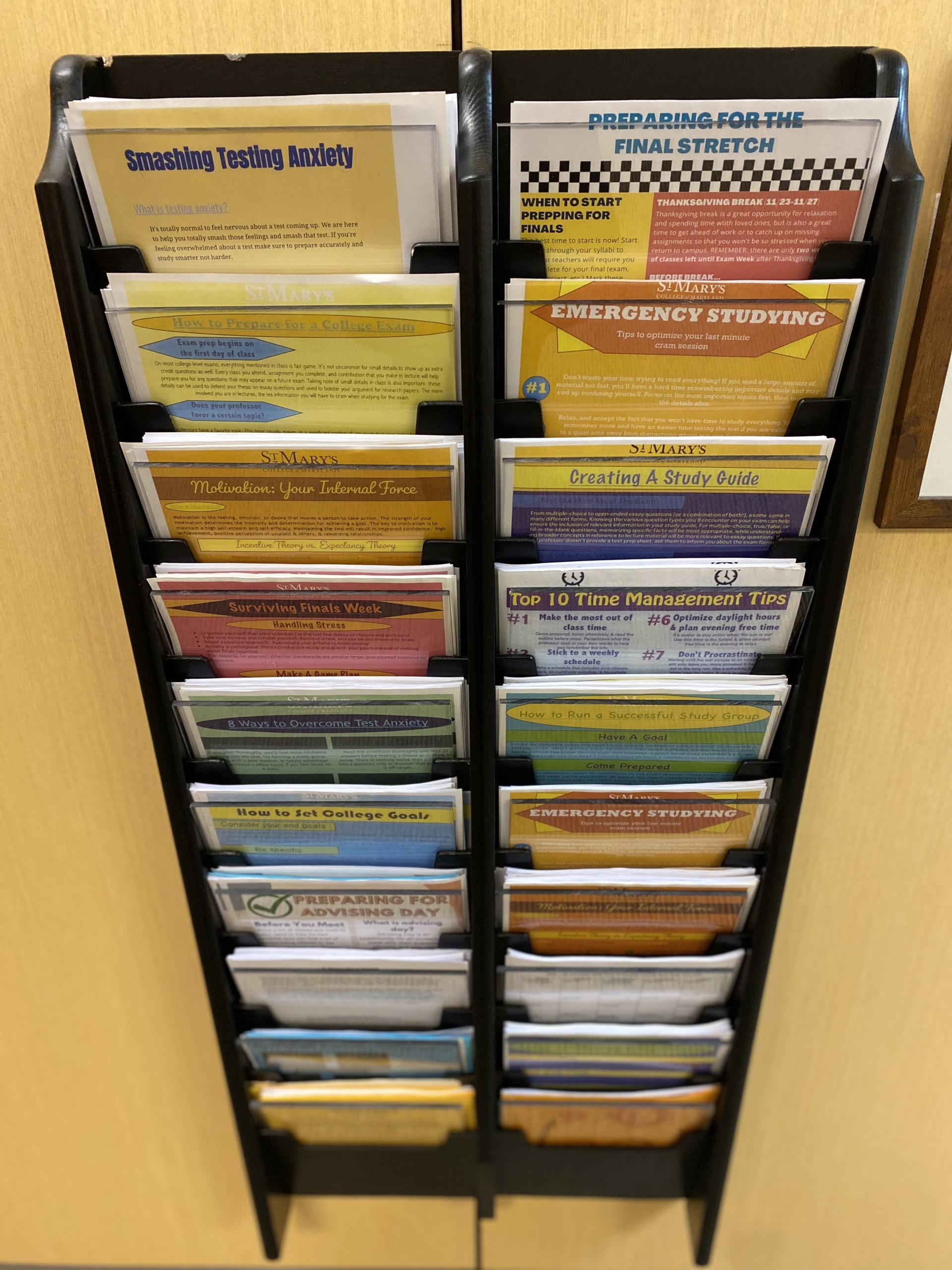 A photograph of a flyer wall in the Office of Student Success Services (OS3).