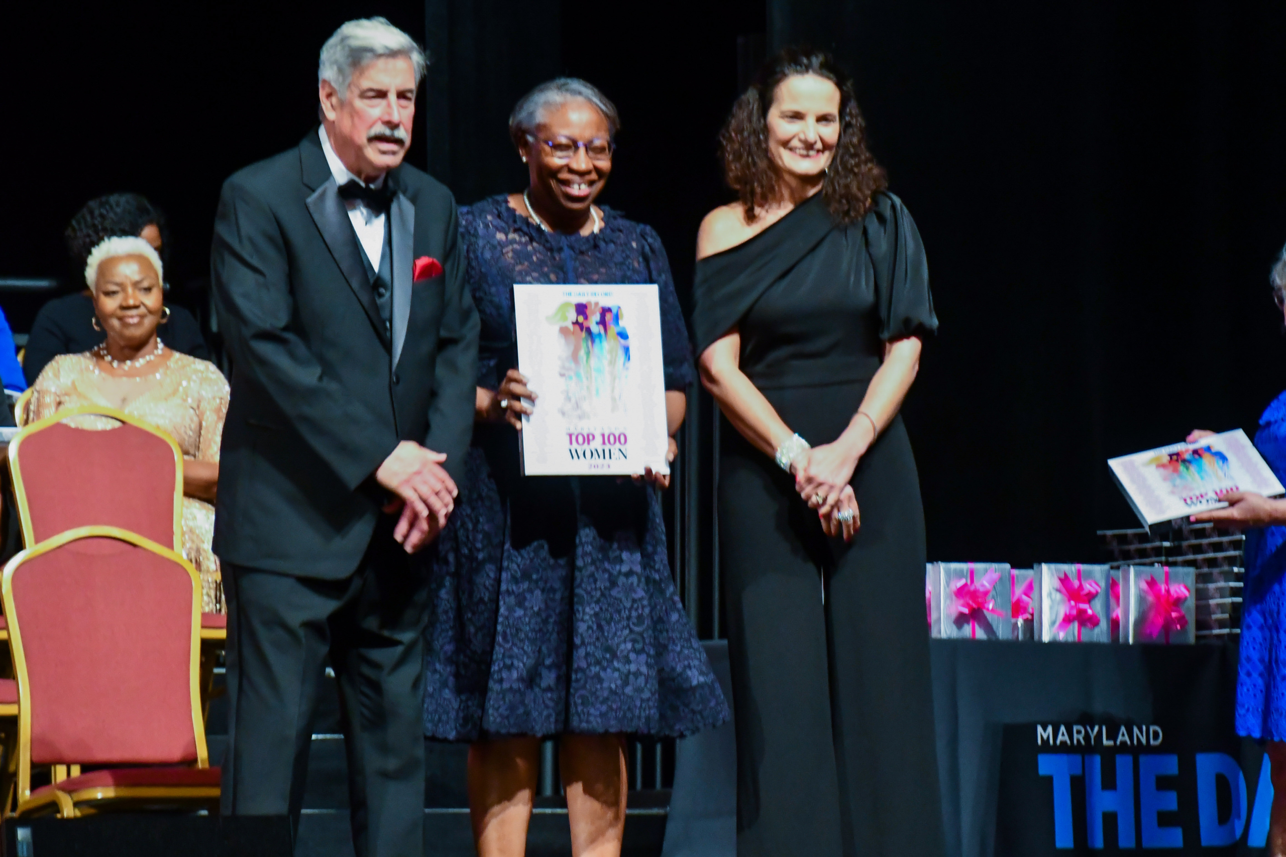 President Jordan poses with The Daily Record staff for a photo as she receives her award for being named to Maryland's Top 100.