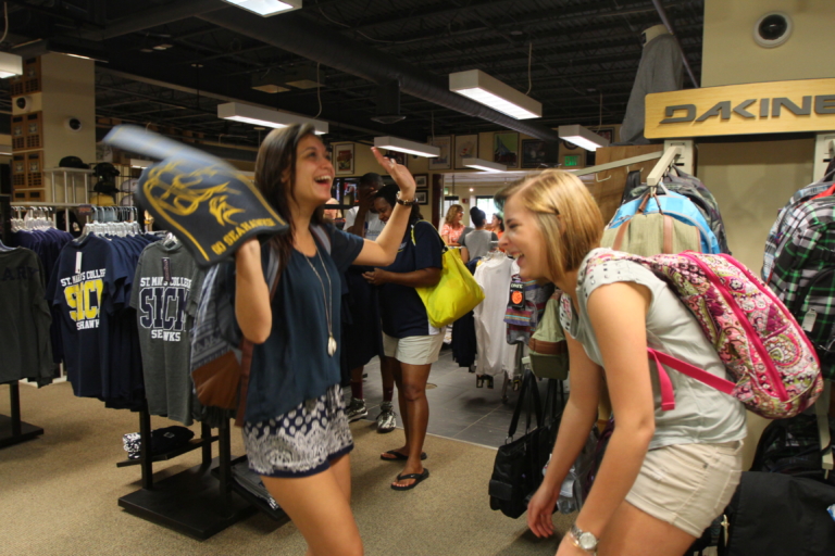 two students talking and joking around in the SMCM bookstore