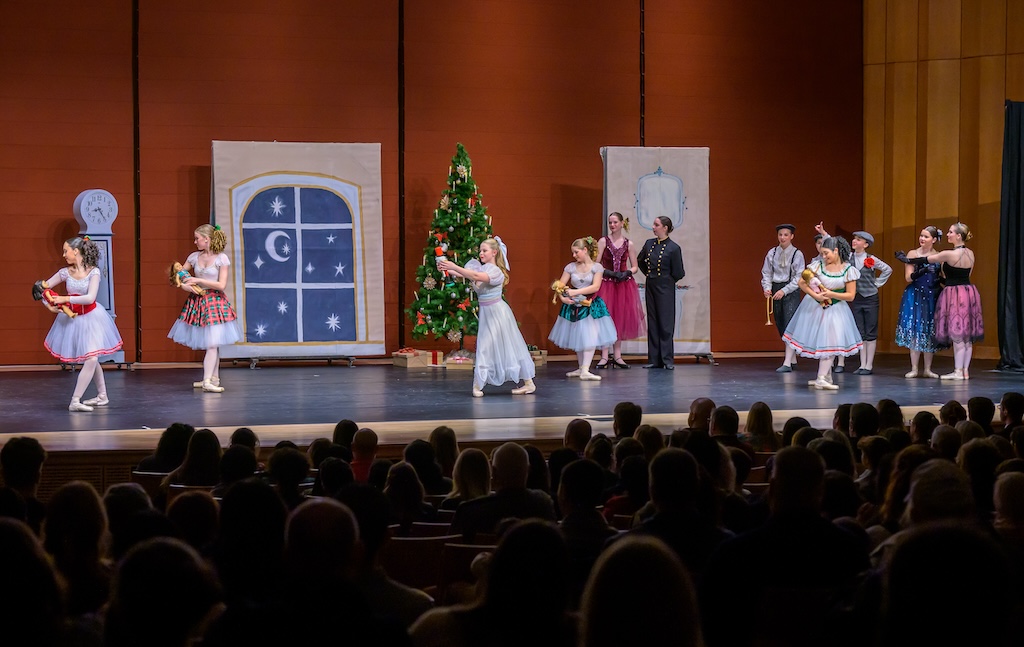 Image of young performers in dresses on stage