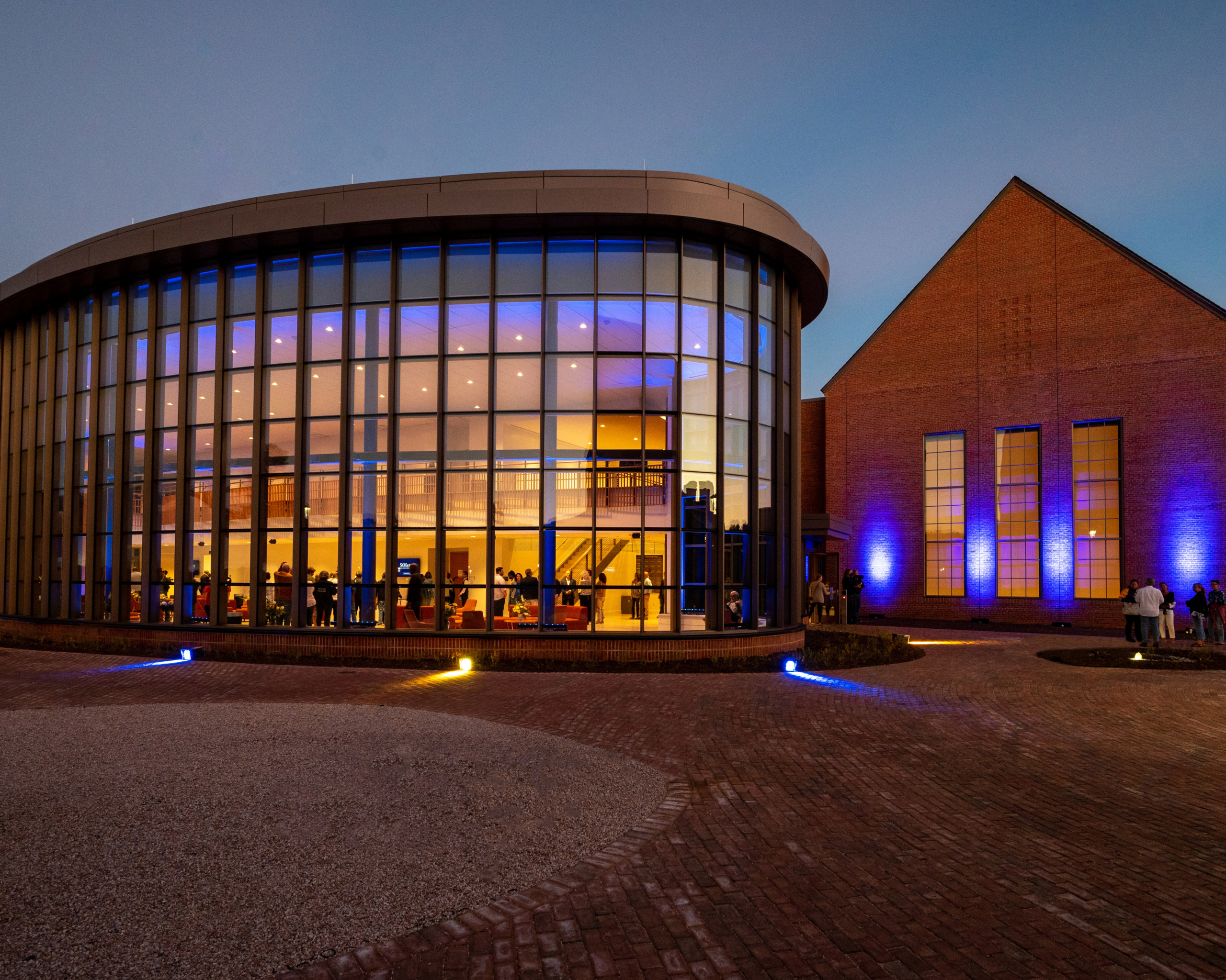 Evening at the Nancy R. and Norton T. Dodge Performing Arts Center glowing from within.