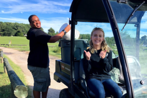 Two compost volunteers riding in vehicle